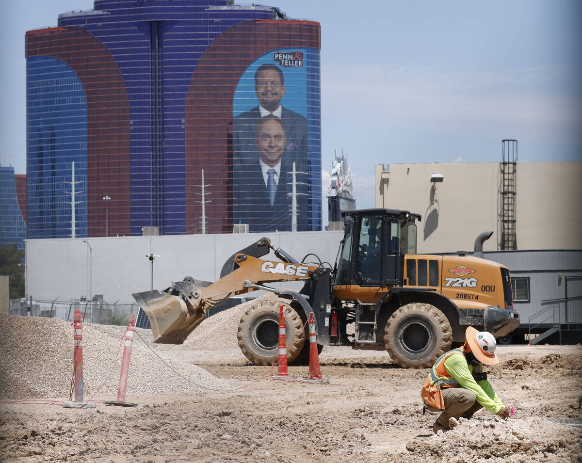 Workers work at a construction site where developer Jonathan Fore plans to build a seven-story, ...
