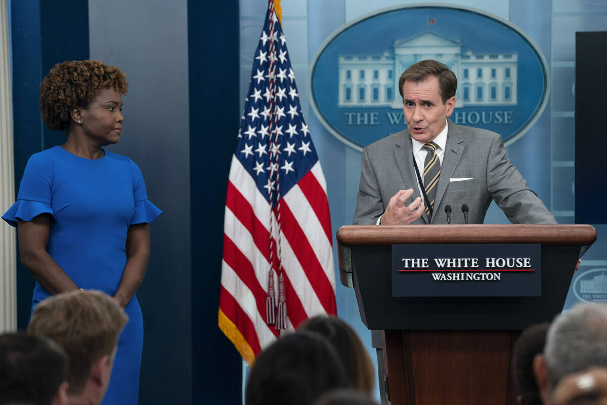 White House press secretary Karine Jean-Pierre listens as National Security Council spokesman J ...