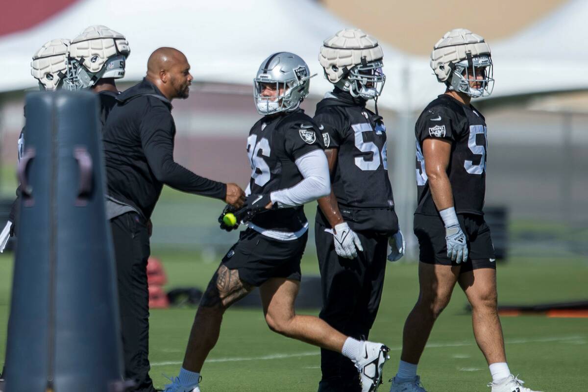 Raiders linebacker coach Antonio Pierce guides linebackers Curtis Bolton III (36), Denzel Perry ...