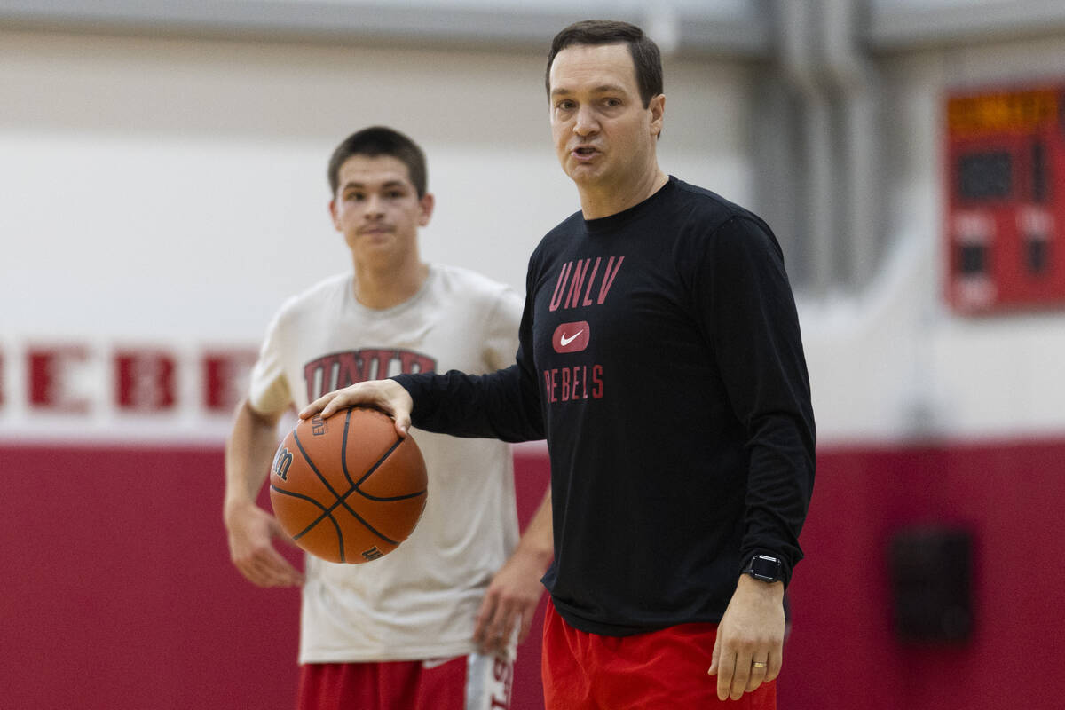 Head coach Kevin Kruger gives his players directions during a team basketball practice at Mende ...