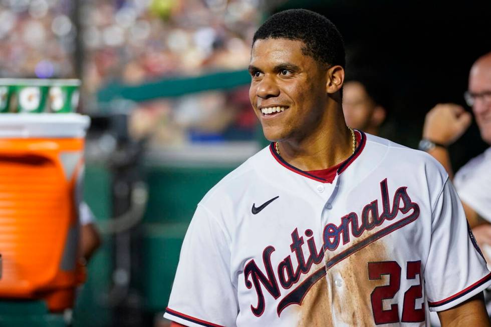 FILE - Washington Nationals' Juan Soto smiles in the dugout after a solo home run during a base ...
