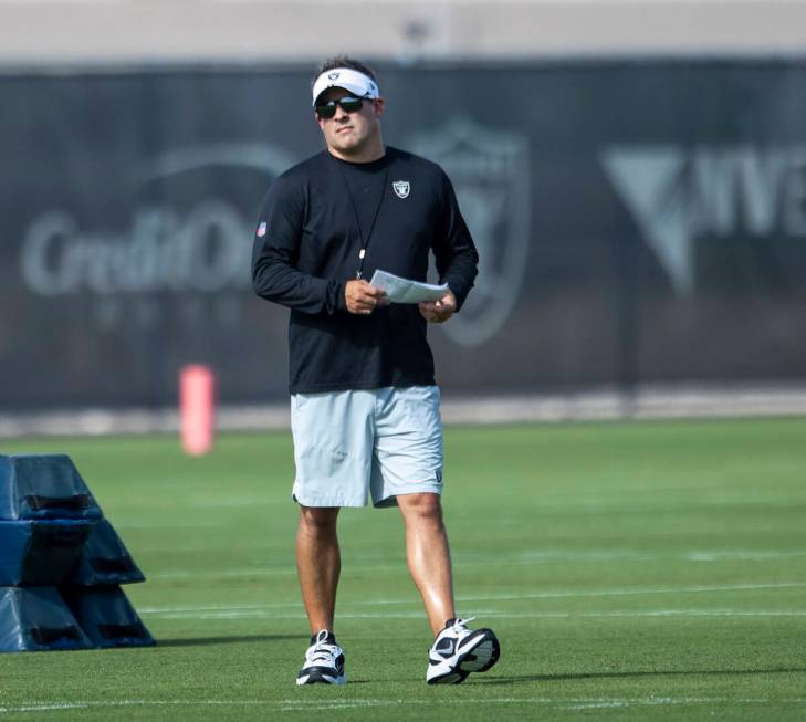 Raiders head coach Josh McDaniels walks the field during the team’s training camp practi ...