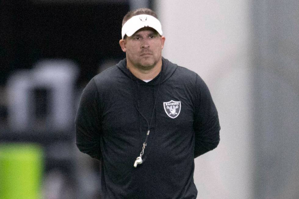 Raiders head coach Josh McDaniels walks the field during the team’s training camp practi ...