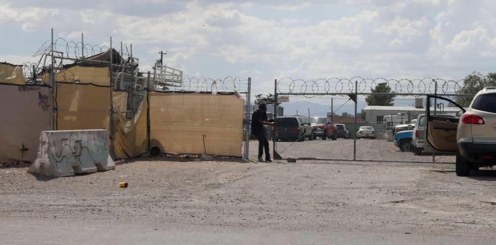 A man closes a gate after a Las Vegas police left the 3000 block of Betty Lane, Tuesday, Aug. 2 ...