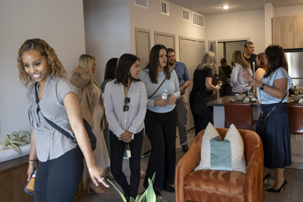 A group takes a tour during an opening event at Ely at Fort Apache apartments on Tuesday, Aug. ...