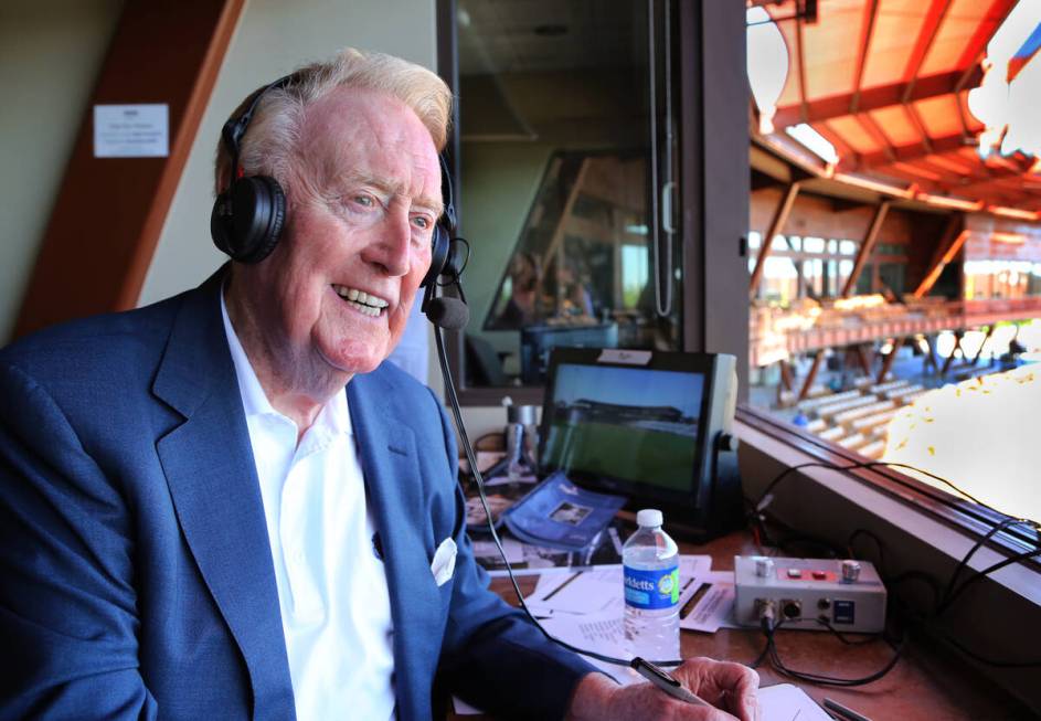 Vin Scully sits in the booth at the ballpark in Glendale, Ariz., for a spring training baseball ...