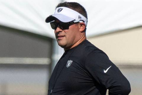 Raiders head coach Josh McDaniels walks the field during the team’s training camp practi ...