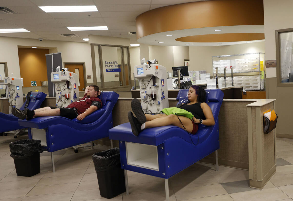 Mark Conoly of Las Vegas and Tracy Hernandez of Las Vegas donate their plasma at the Grifols Bi ...