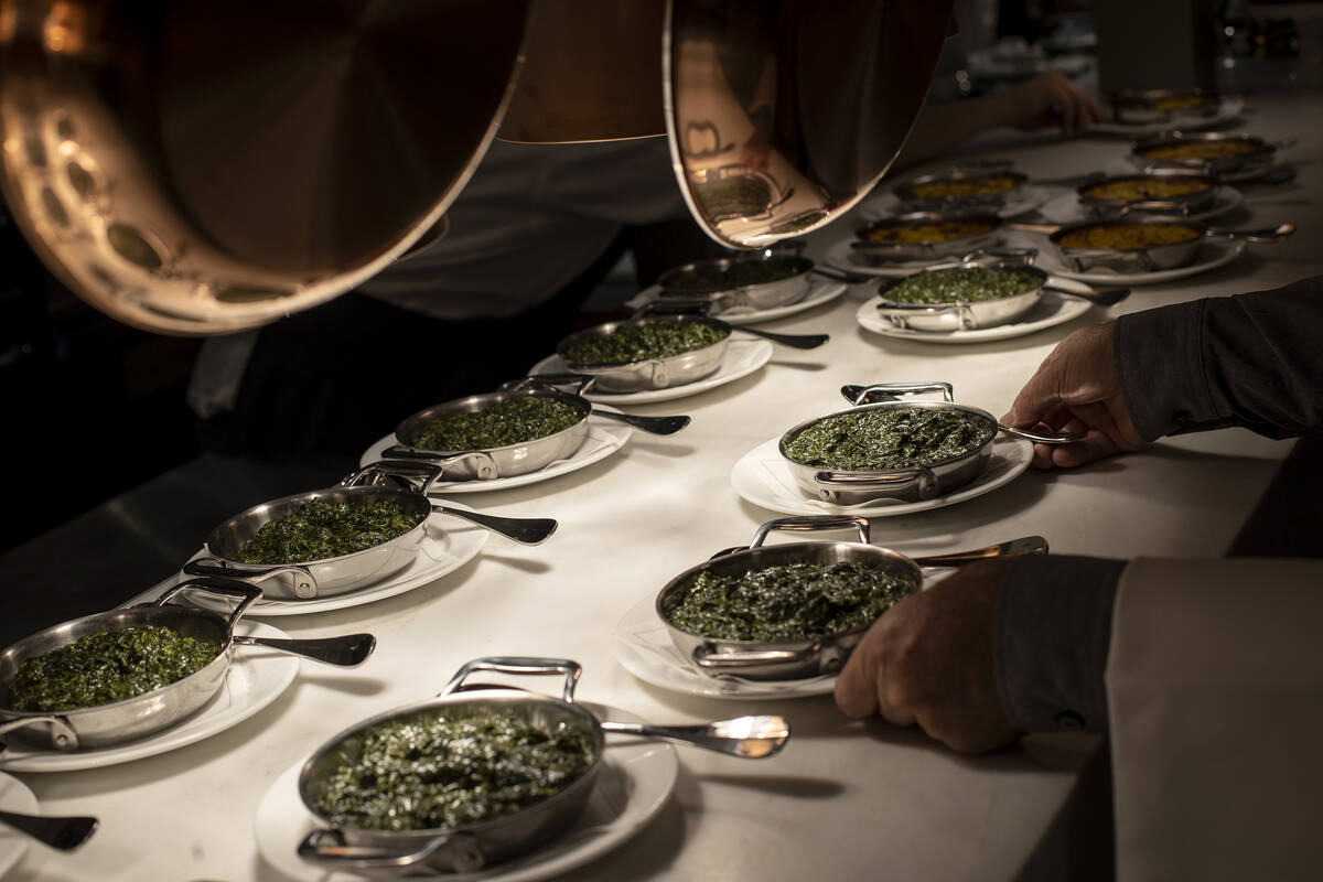 Creamed spinach is lined up on the pass during a media roundtable lunch ahead of opening night ...