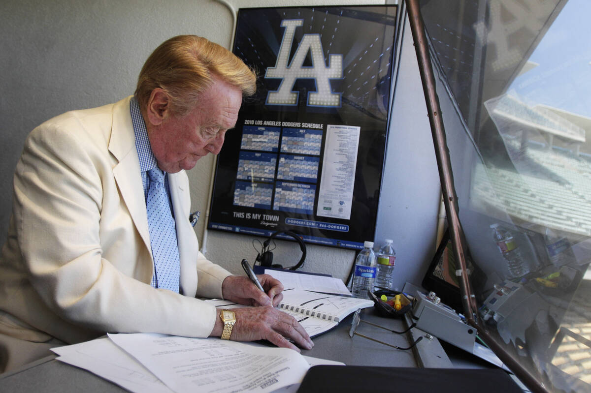 Vin Scully works in his booth at Dodger Stadium in Los Angeles on Aug. 22, 2010. (AP Photo/Jae ...