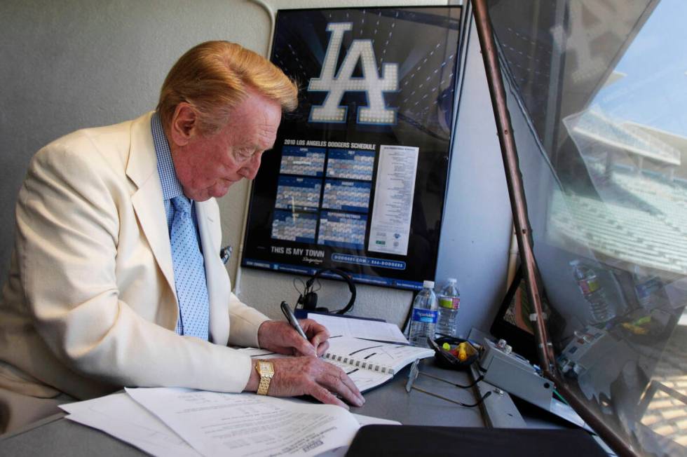 Vin Scully works in his booth at Dodger Stadium in Los Angeles on Aug. 22, 2010. (AP Photo/Jae ...