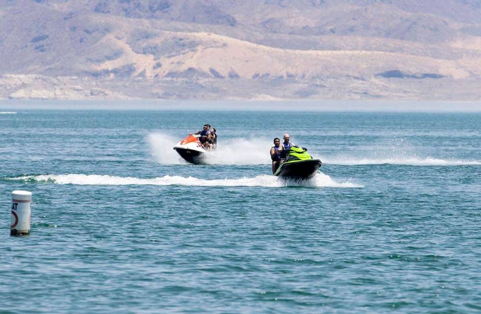 People rid their jet ski at Boulder Beach in the Lake Mead National Recreation Area, on Friday, ...