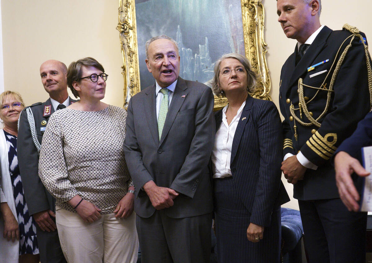 Senate Majority Leader Chuck Schumer, D-N.Y., flanked by Paivi Nevala, minister counselor of th ...