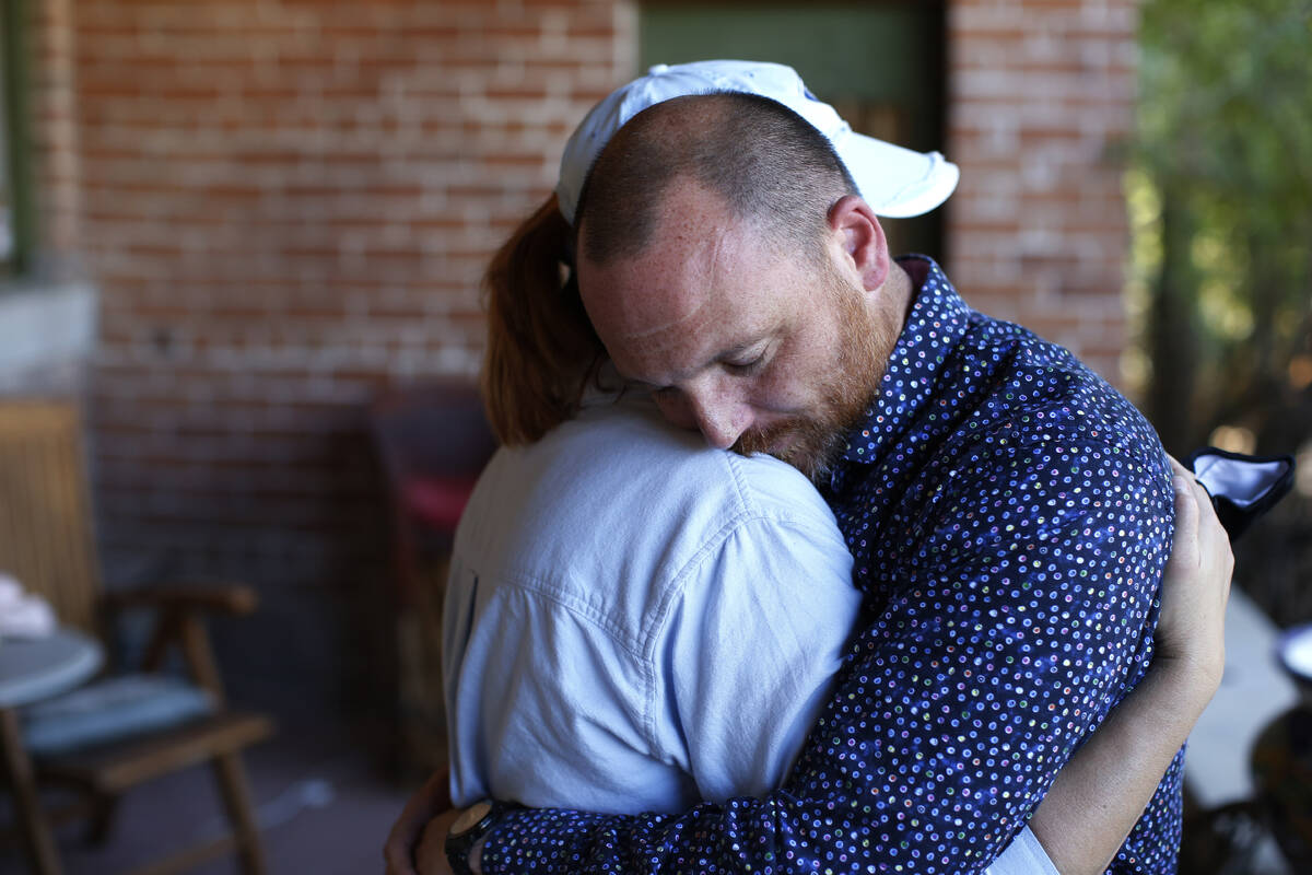 Matthew and Miranda Whitworth embrace at the home of the attorney representing their adoptive d ...