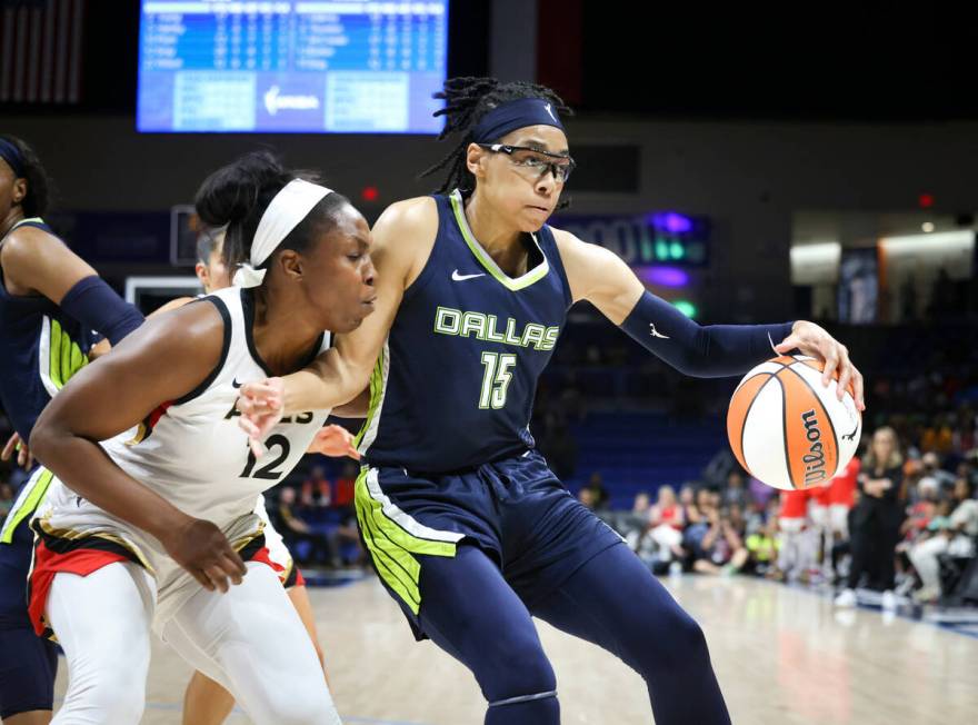 Las Vegas Aces guard Chelsea Gray (12) defends against Dallas Wings guard Allisha Gray during a ...