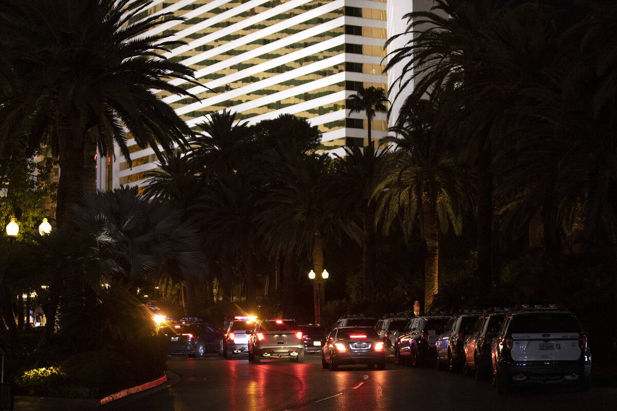 A line of police vehicles leads to the entrance of The Mirage where Las Vegas police are respon ...