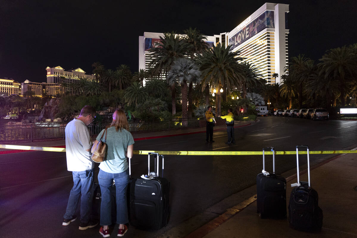 Hotel guests wait to enter The Mirage while Las Vegas police investigate a fatal shooting in th ...
