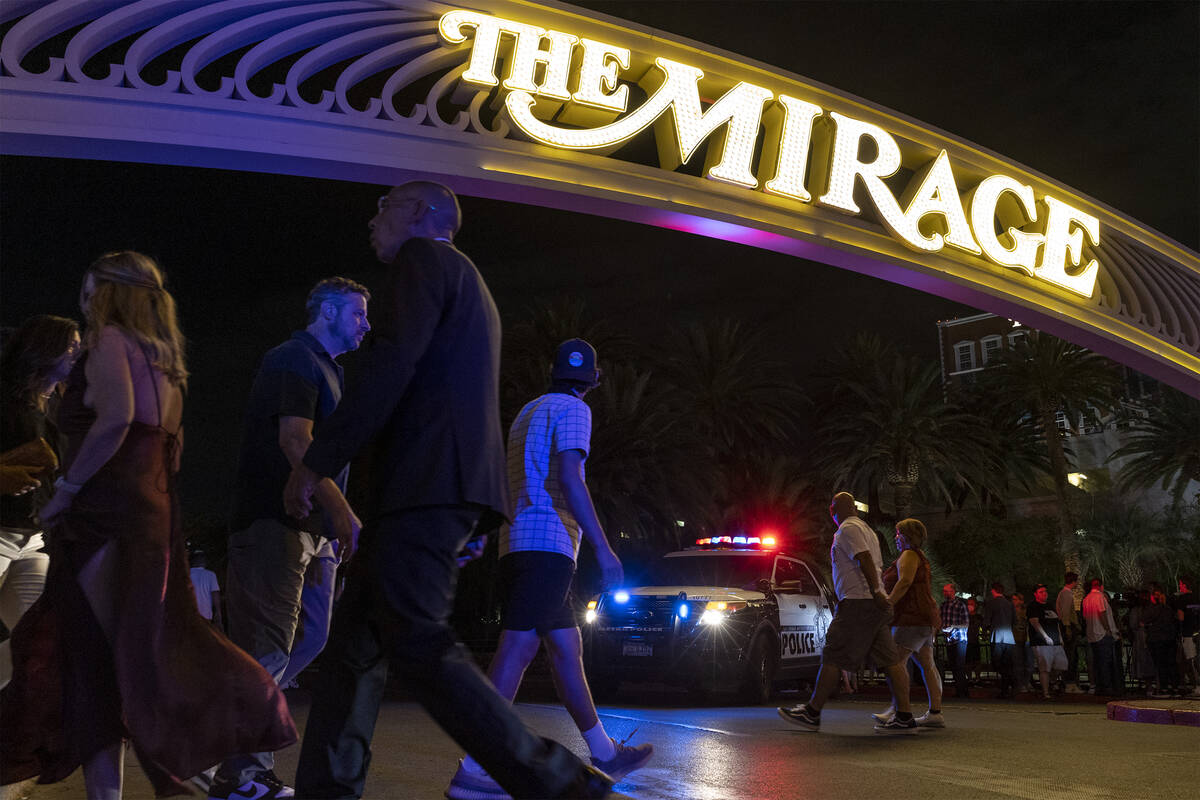 Pedestrians pass The Mirage while Las Vegas police respond to a fatal shooting in the hotel on ...