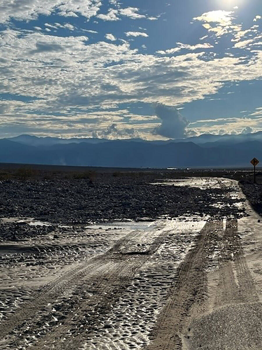 Mud and debris cover a road in Death Valley National Park on Saturday, Aug. 6, 2022. Historic f ...