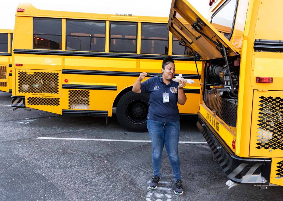 Stacee Lopez, a school bus driver, inspects her bus at the Arville Transportation Yard as she p ...
