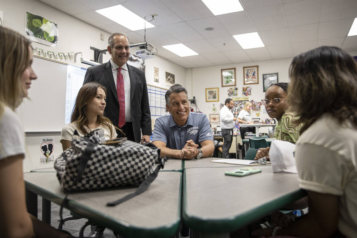 University of Nevada-Reno President Brian Sandoval, center, talks with students who are doing t ...