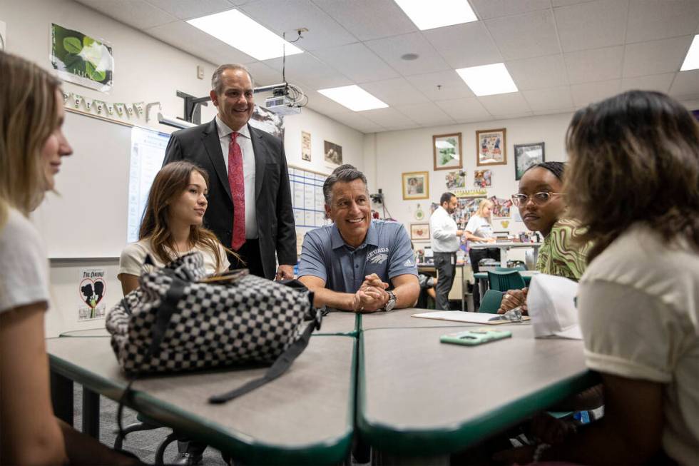 University of Nevada-Reno President Brian Sandoval, center, talks with students who are doing t ...