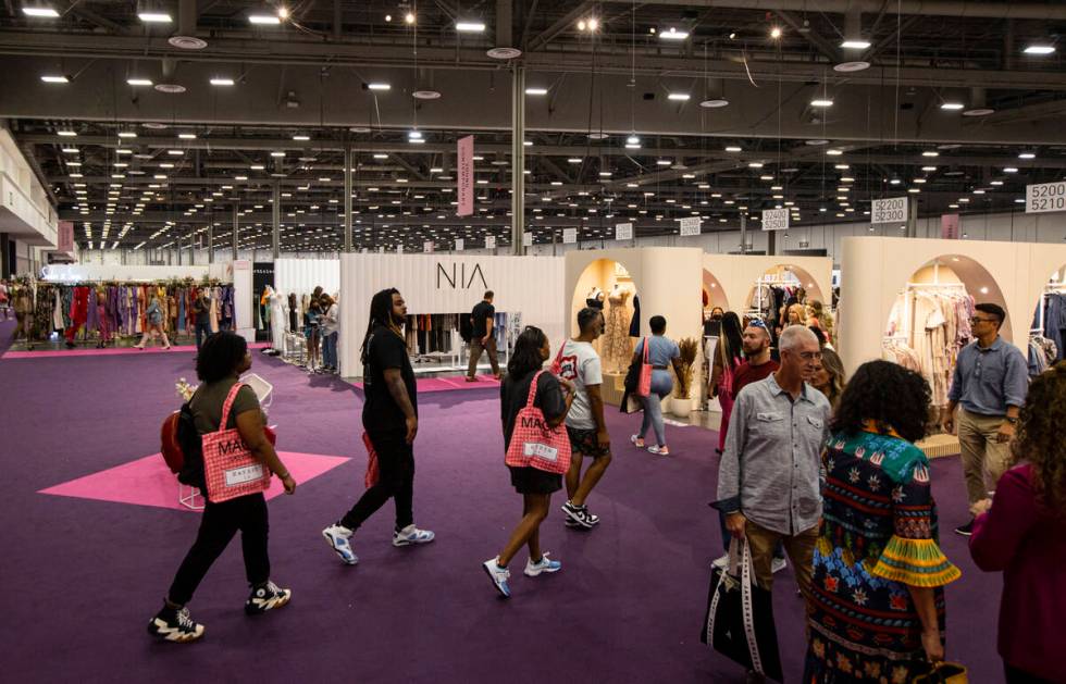 People walk the show floor during the MAGIC Las Vegas fashion trade show on Monday, Aug. 8, 202 ...