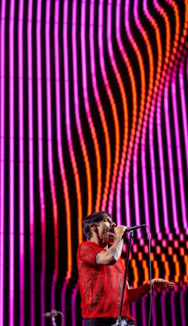 (From left) Lead singer Anthony Kiedis sings with The Red Hot Chili Peppers at Allegiant Stadiu ...