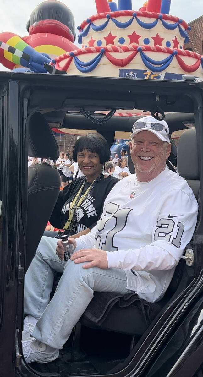 Cliff Branch's sister Elaine Anderson and Raiders owner Mark Davis are shown riding in the Gran ...