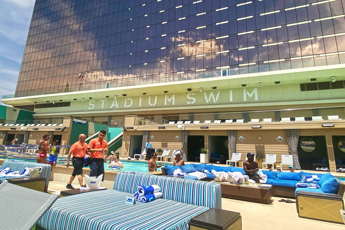 Employees and pool-goers at Circa Resort's Stadium Swim on July 22, 2022. Lifeguards working in ...