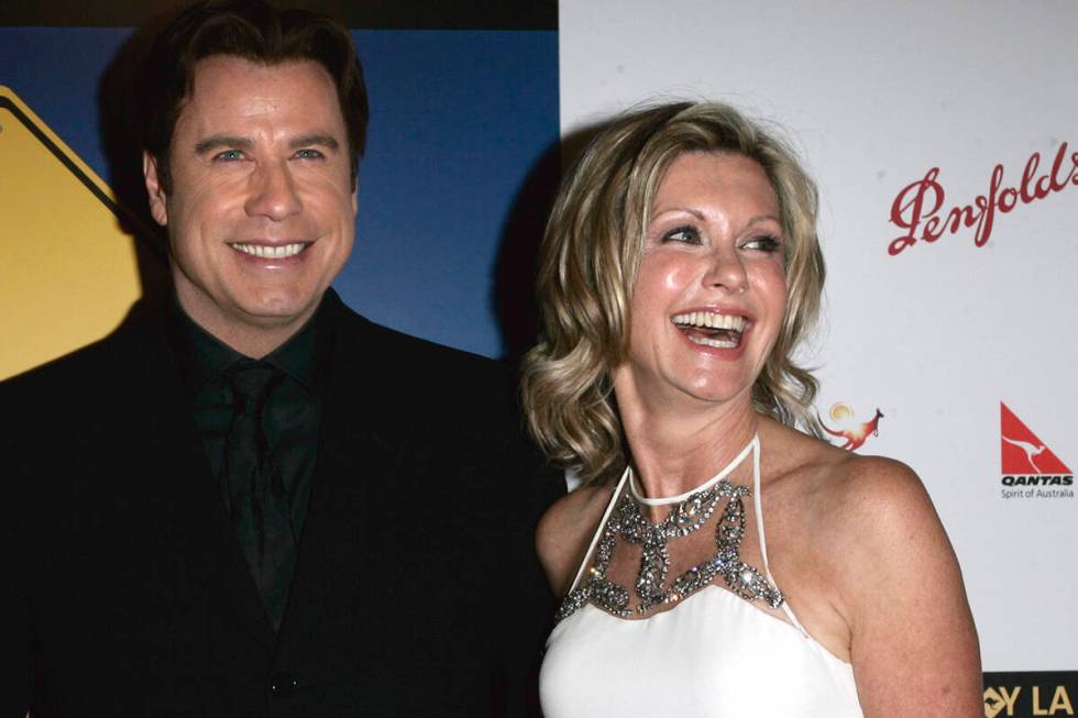 John Travolta, left, and Olivia Newton-John arrive at the The Penfolds Icon Gala Dinner in Los ...