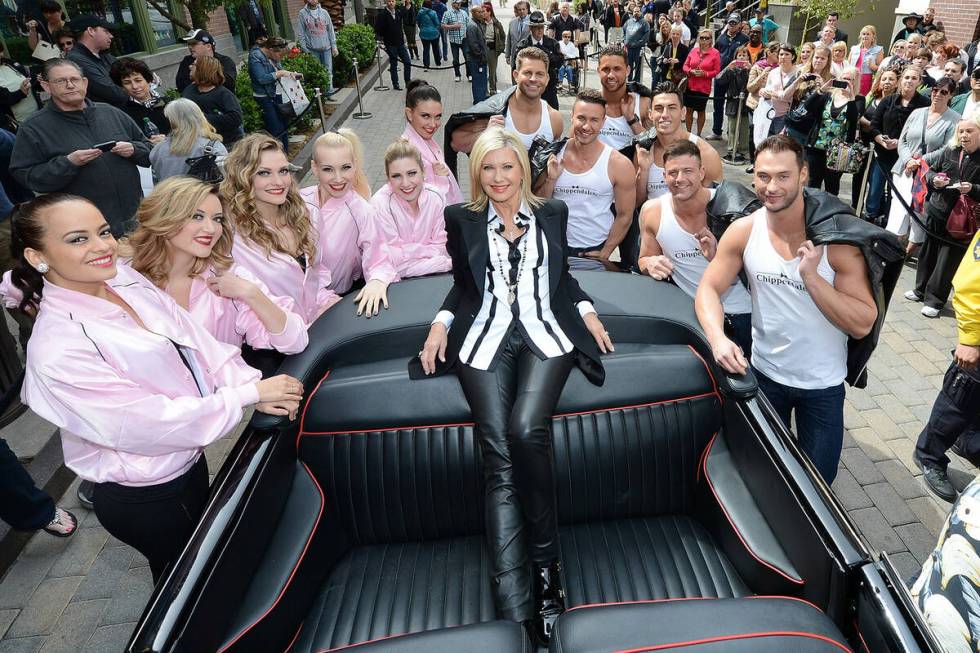 Olivia Newton-John is greeted by Las Vegas entertainers from the shows "Jubilee" and "Chippenda ...