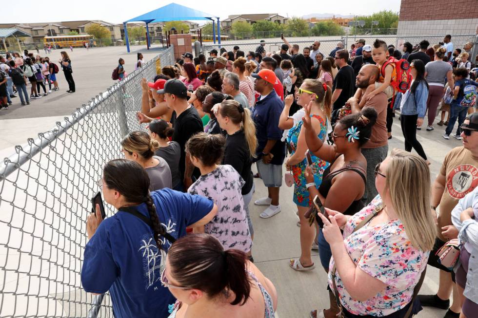 Parents watch their children head off for the first day of the school year at Hayden Elementary ...