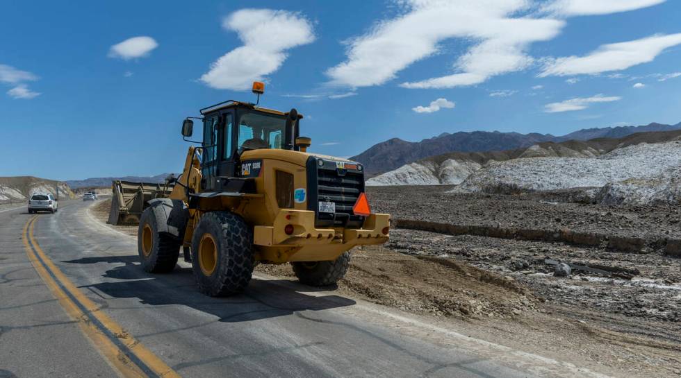 Construction machinery continues to clear State Route 190 of mud flows within Death Valley Nati ...