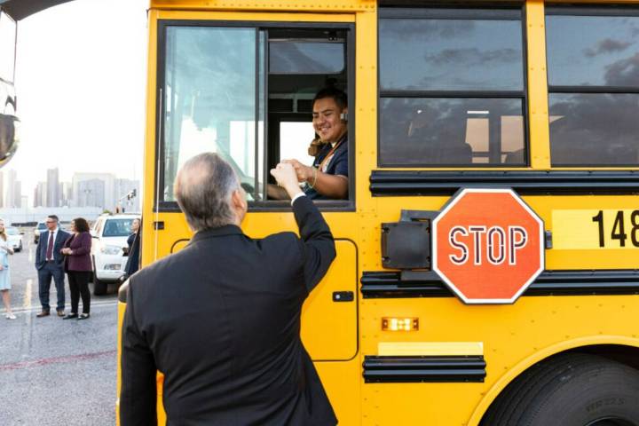 Clark County School District Superintendent Jesus Jara fist bumps with a school bus driver at t ...