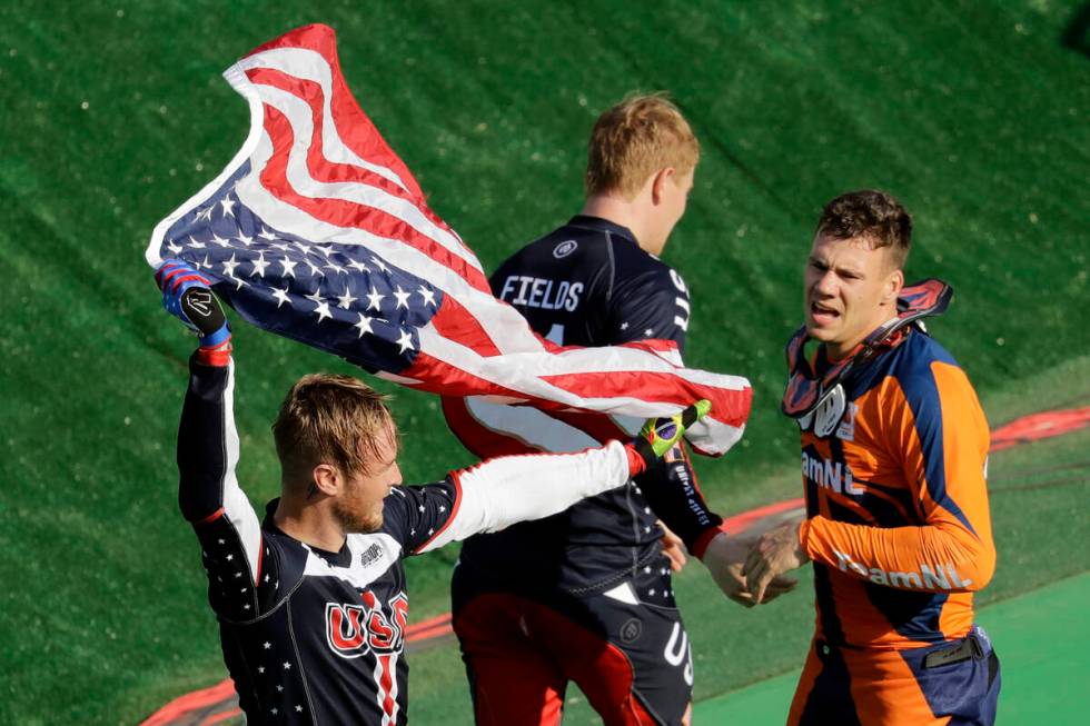 Fourth place Nicholas Long of the United States, left, waves a U.S. flag next to second place J ...