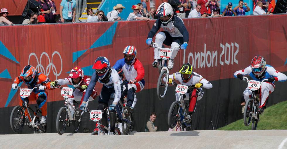 United States' Connor Fields (11) leads the competition in a BMX cycling men's quarterfinal ru ...