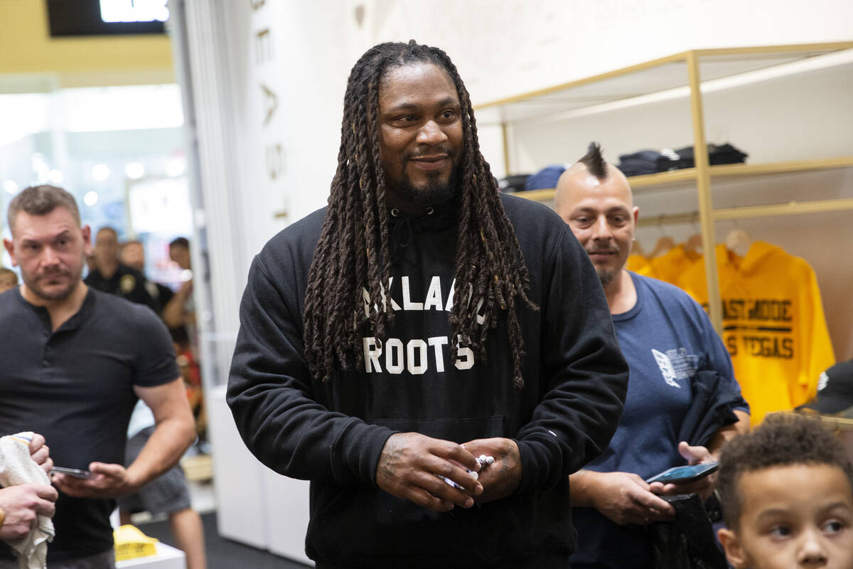 NFL running back Marshawn Lynch interacts with fans and customers at the opening of his store, ...