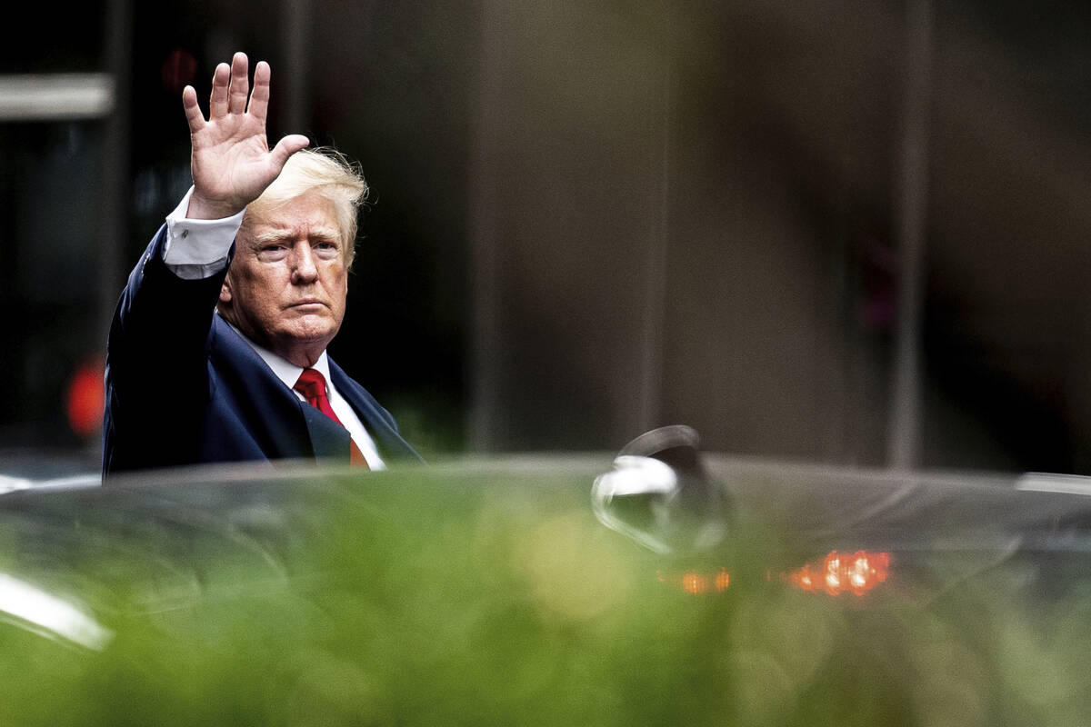 Former President Donald Trump waves as he departs Trump Tower, Wednesday, Aug. 10, 2022, in New ...