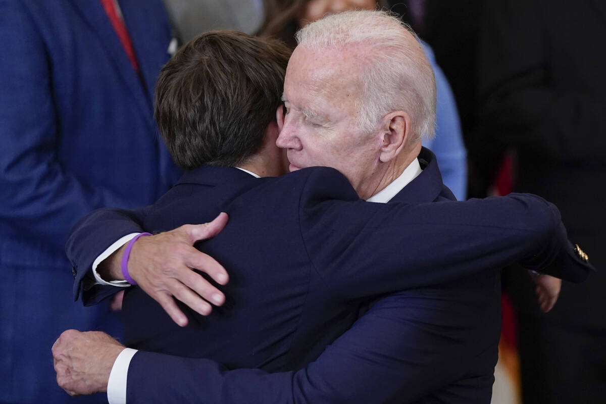President Joe Biden hugs his grandson Robert Biden, son of the late Beau Biden, after signing t ...