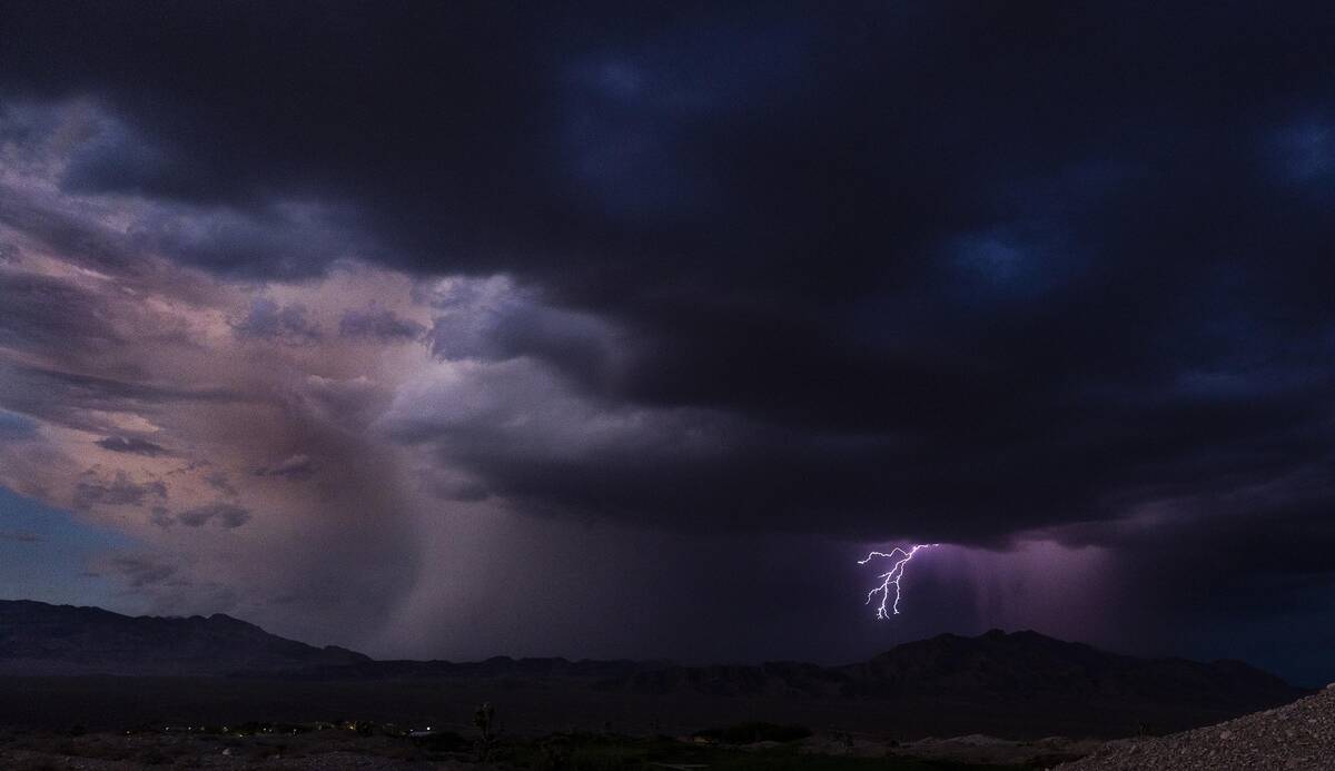 Lightning erupts as a monsoon storm moves across the valley on Thursday, Aug. 11, 2022, in Las ...