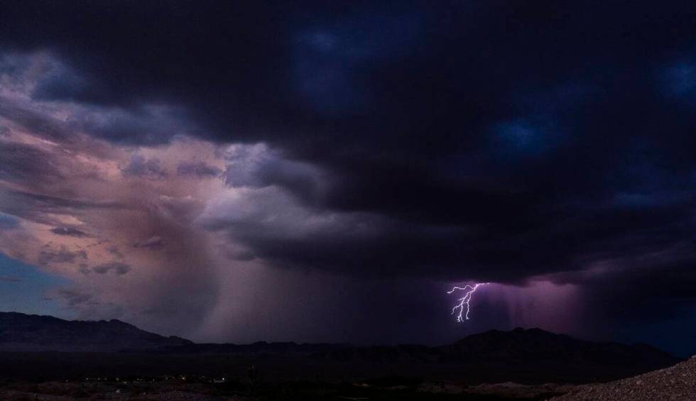 Lightning erupts as a monsoon storm moves across the valley on Thursday, Aug. 11, 2022, in Las ...