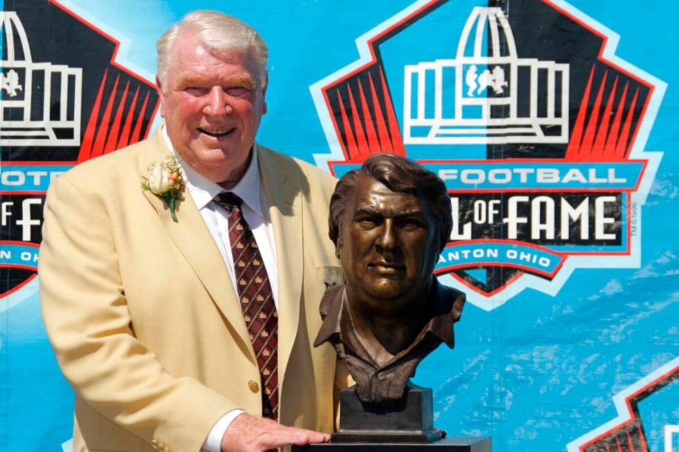 Broadcaster and former Oakland Raiders coach John Madden poses with his bust after enshrinement ...
