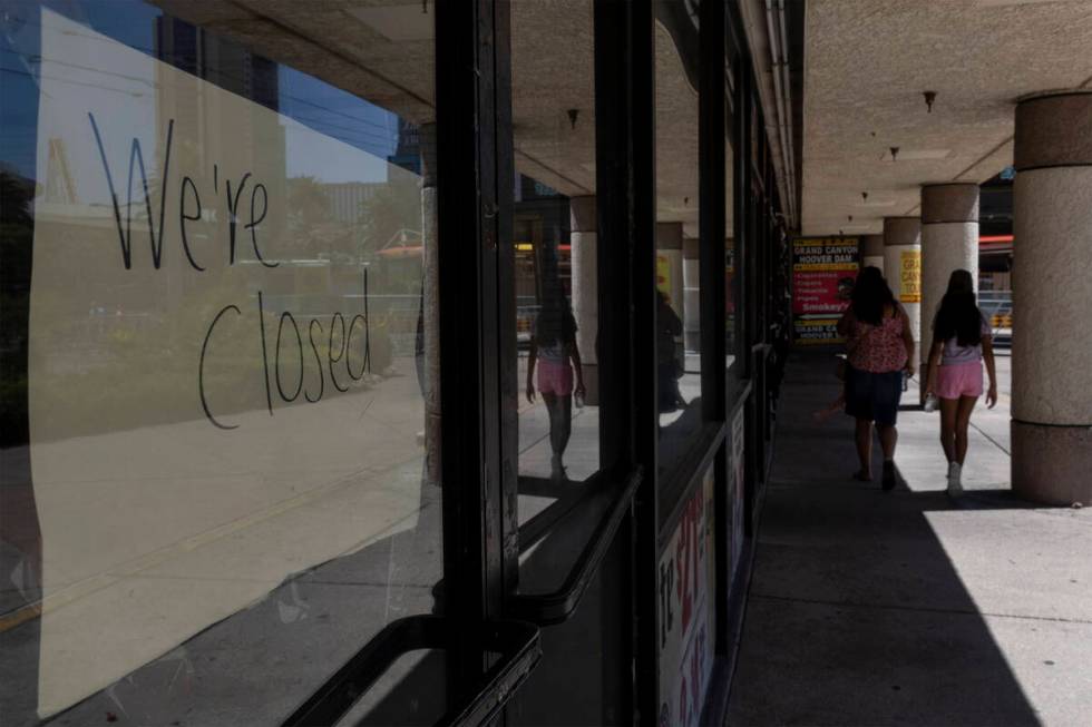 Pedestrians walk past closed stores in the Cable Center Shops, Wednesday, June 29, 2022, on the ...