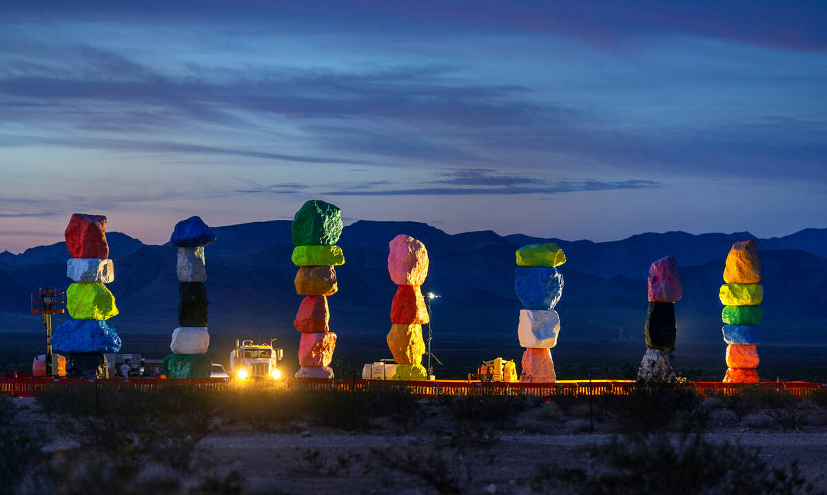 Work lights illuminate the Seven Magic Mountains early in the morning as the art installation u ...