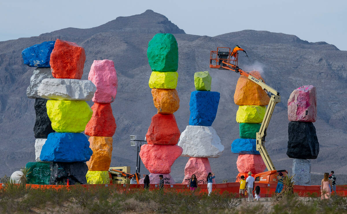 Journeyman Painter Ivan Barerra pressure washes stones at Seven Magic Mountains as the art inst ...