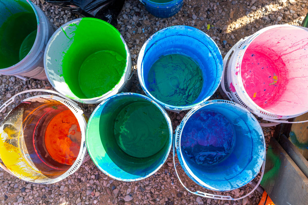 Color mixing buckets at the ready as Seven Magic Mountains undergoes routine maintenance with f ...