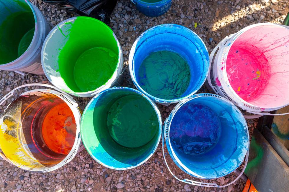 Color mixing buckets at the ready as Seven Magic Mountains undergoes routine maintenance with f ...