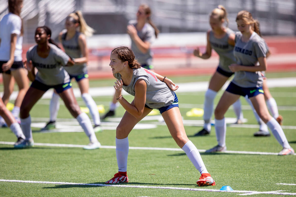 Xayla Black helps lead the Coronado High School girls soccer team in stretches during practice ...