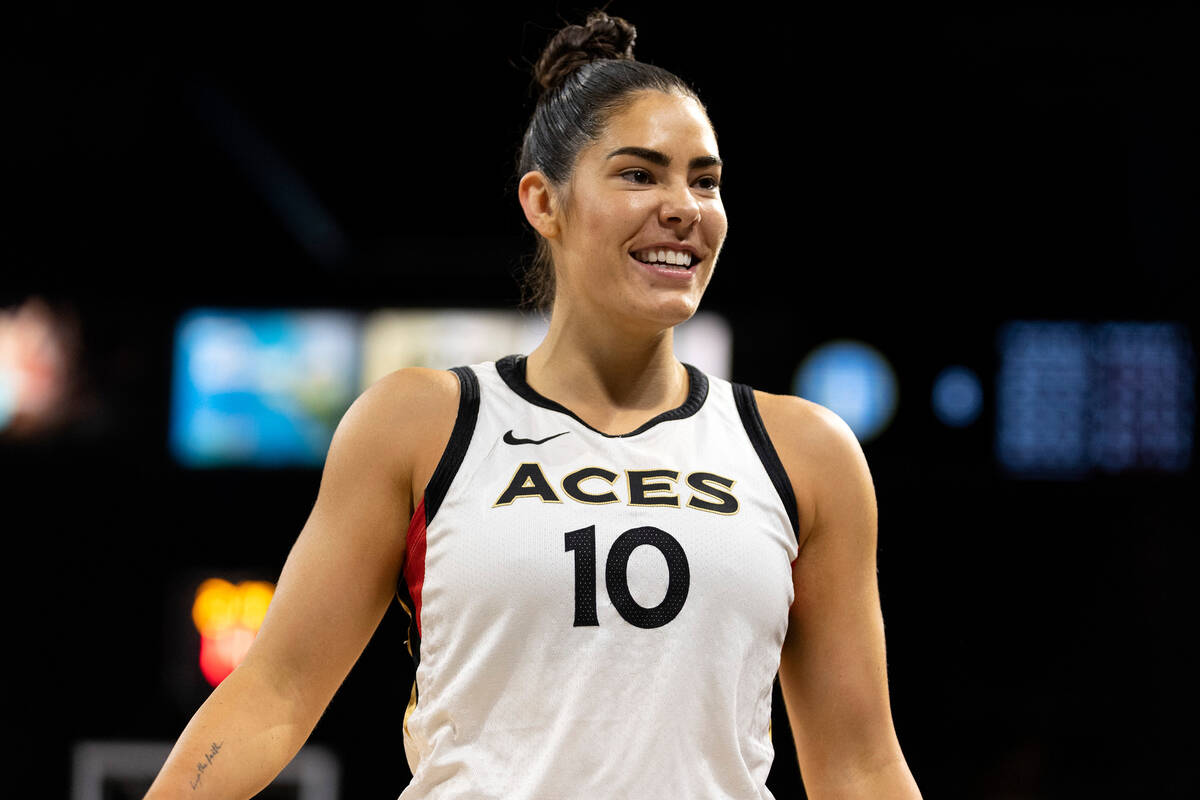 Las Vegas Aces guard Kelsey Plum (10) smiles at a play made by guard Jackie Young (0) during th ...